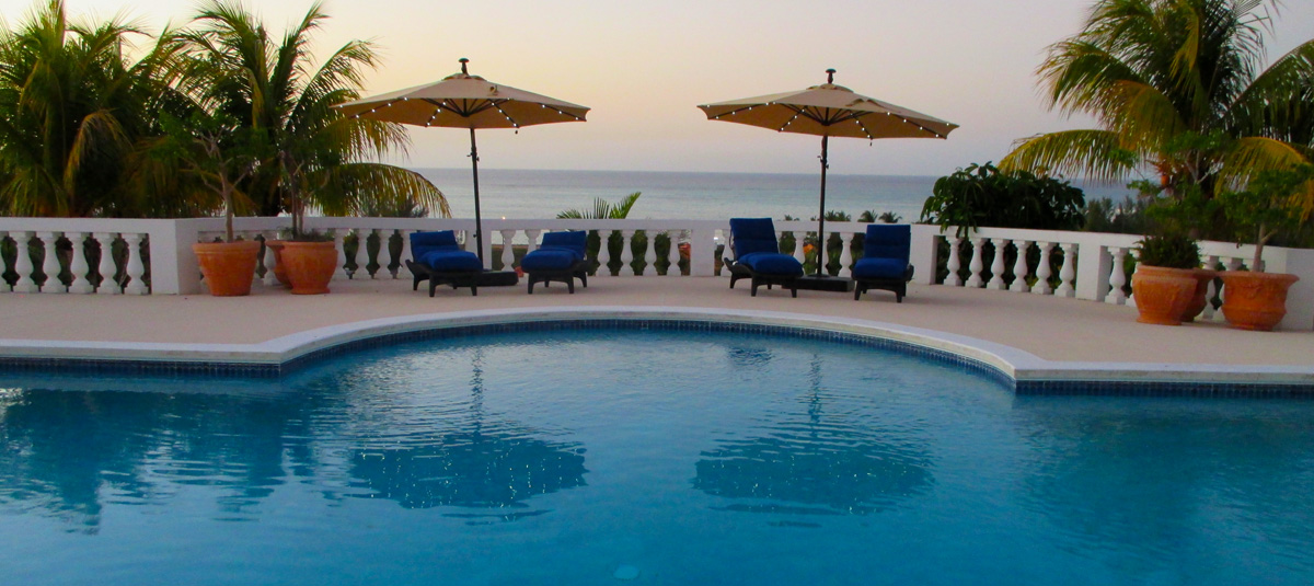 Ocean West pool terrace overlooking the sea at dusk